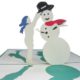 girl putting magic hat on Frosty the snowman pop up card detail